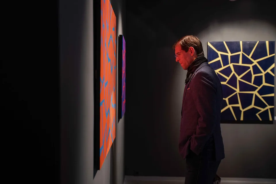 A visitor looking at a painting